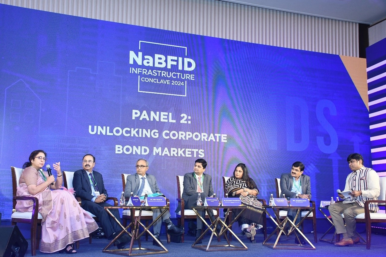 Panel Discussion on Unlocking Corporate Bond Markets at NaBFID Infrastructure Conclave 2024 Panel Members and Moderator (L-R): Mrs. Monika Kalia, DMD NaBFID, Mr. Anup Bagchi, Managing Director & CEO, ICICI Prudential Life Insurance, Mr. Ravindranath Gandrakota, CEO, FIMMDA, Mr. Prathamesh Sahasrabudhe, Managing Director & Head, Capital Markets, India & South Asia, Mrs. Nipa Sheth, Director, Trust Group, Mr. Jitendra Shah, MD, Tipsons Group and Mr. Nitin Jaiswal, Head of Asia-Pacific for Strategic Relations & Initiatives, Bloomberg